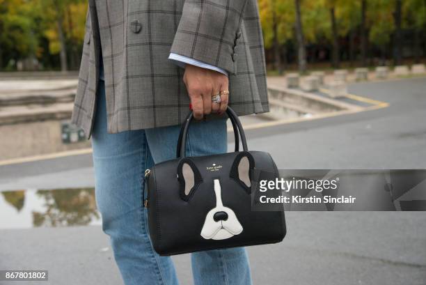 Fashion blogger Tiany Kiriloff of belmodotiany wears a Dries van Noten jacket, Levi"u2019s jeans and a Kate Spade bag day 3 of Paris Womens Fashion...