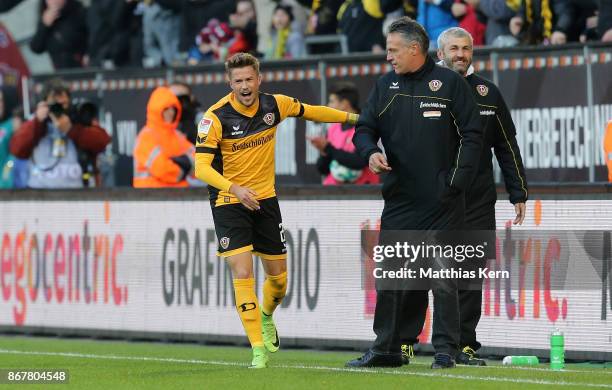 Patrick Moeschl of Dresden jubilates with head coach Uwe Neuhaus after scoring the first goal during the Second Bundesliga match between SG Dynamo...