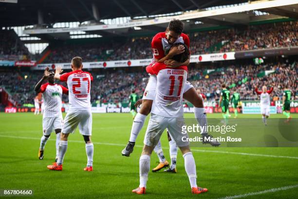 Michael Gregoritsch of Augsburg celebrates with Rani Khedira after scoring his team's first goal to make it 0-1 during the Bundesliga match between...