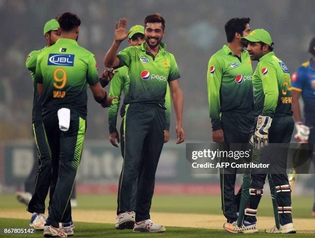 Pakistani bowler Mohammad Amir celebrates with teammates after dismissing Sri Lankan batsman Dilshan Munaweera during the third and final T20 cricket...