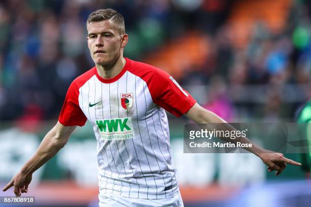 Alfred Finnbogason of Augsburg celebrates after scoring penalty shot to make it 0-2 during the Bundesliga match between SV Werder Bremen and FC...