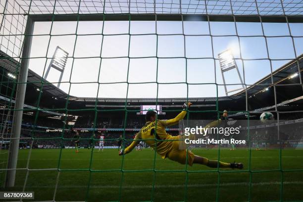 Alfred Finnbogason of Augsburg scores from the penalty spot against Jiri Pavlenka goal keeper of Bremen to make it 0-2 during the Bundesliga match...