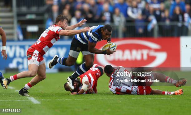 Semesa Rokoduguni of Bath is challenged by Henry Trinder and David Halaifonua of Gloucester during the Aviva Premiership match between Bath Rugby and...