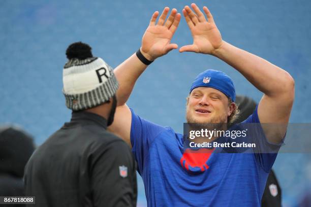 Manuel of the Oakland Raiders and Eric Wood of the Buffalo Bills talk before an NFL game on October 29, 2017 at New Era Field in Orchard Park, New...