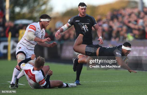 Sinoti Sinoti of Newcastle Falcons is tackled by Mathew Tait of Leicester Tigers during the Aviva Premiership match between Newcastle Falcons and...