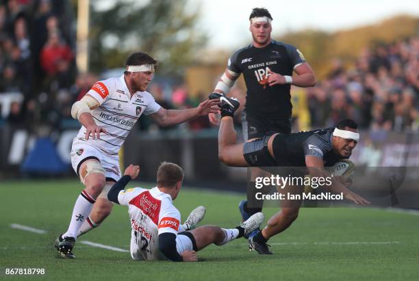 Sinoti Sinoti of Newcastle Falcons is tackled by Mathew Tait of Leicester Tigers during the Aviva Premiership match between Newcastle Falcons and...