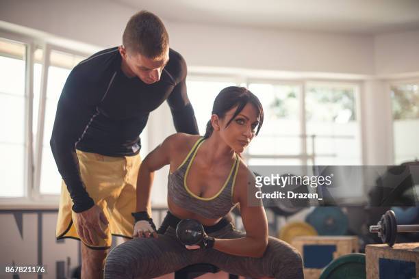 woman exercising in gym - women's weightlifting stock pictures, royalty-free photos & images