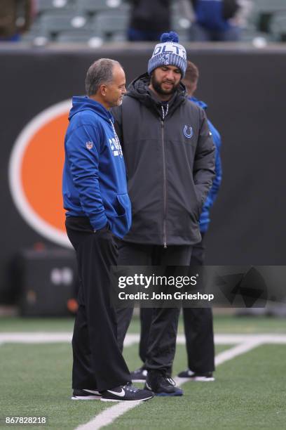 Head Coach Chuck Pagano of the Indianapolis Colts shares a moment with Andrew Luck before the game against the Cincinnati Bengals at Paul Brown...