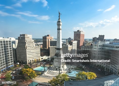 Rush hour right after sunrise over Indiana's Soldiers and Sailors Monument on Monument Circle, Indianapolis, USA Rush hour right after sunrise over Indiana's Soldiers and Sailors Monument on Monument Circle, Indianapolis, USA