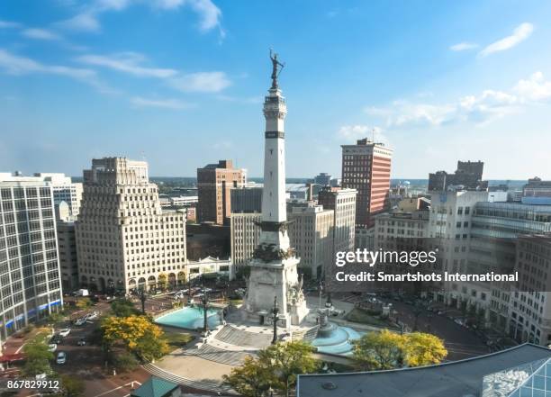 rush hour right after sunrise over indiana's soldiers and sailors monument on monument circle, indianapolis, usa - indiana bildbanksfoton och bilder