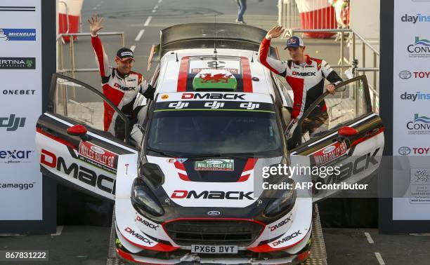British pilot Elfyn Evans and co pilot Daniel Barritt of the M-Sport World Rally celebrate with their Ford Fiesta WRC after winning the 2017 Wales...