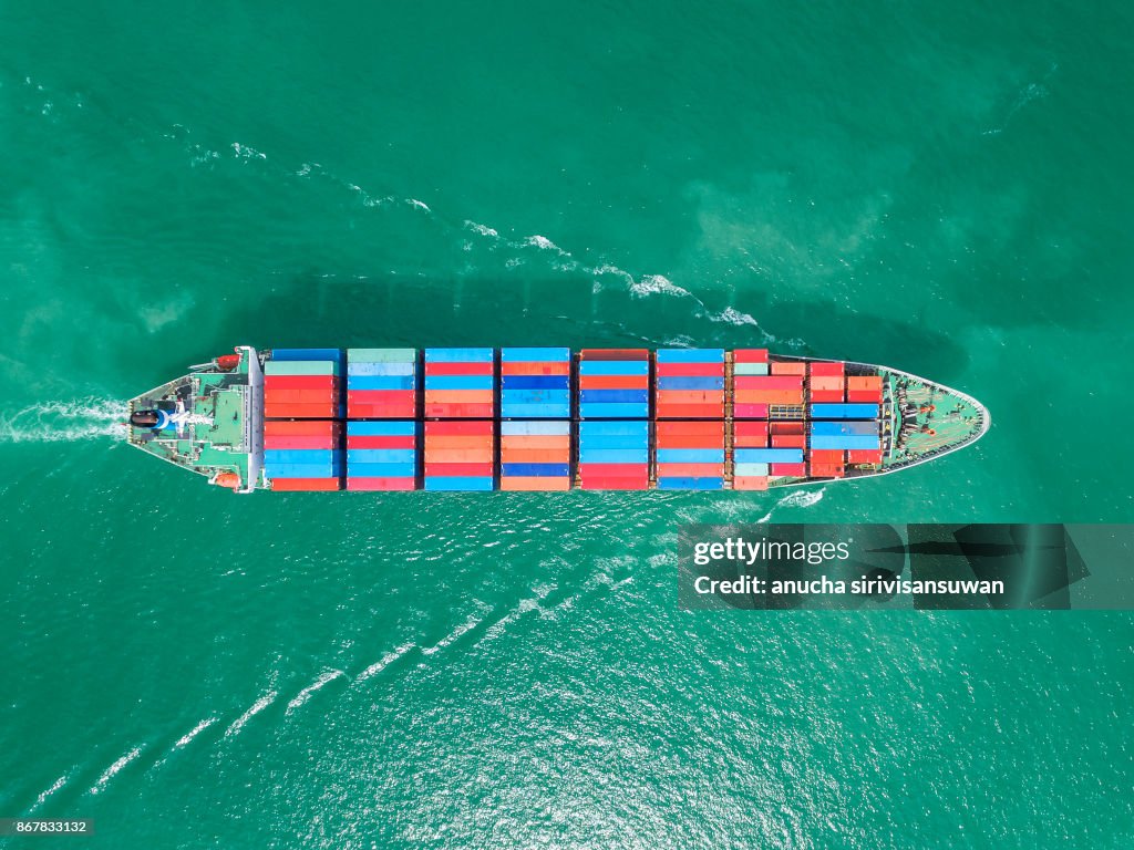Aerial view of cargo ship, cargo container in warehouse harbor at thailand .