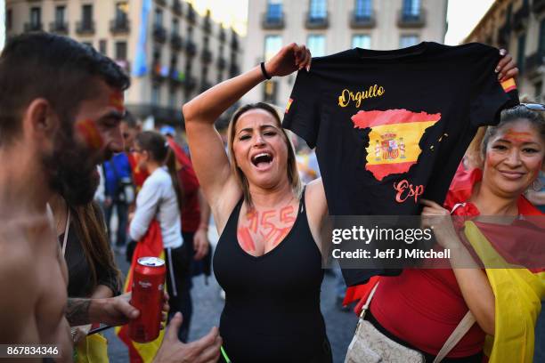 Nationalist supporters gather outside the Palau Catalan Regional Government Building following a pro-unity protest in Barcelona, two days after the...