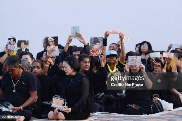Thai mourner holds a portrait of the late Thai King Bhumibol Adulyadej in the area of the Grand Palace in Bangkok, Thailand, 29 October 2017.