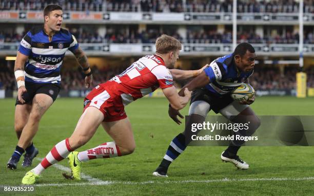 Semesa Rokoduguni of Bath breaks through to score a late try during the Aviva Premiership match between Bath Rugby and Gloucester Rugby at the...