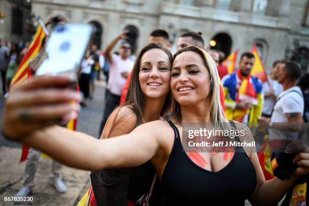 Nationalist supporters gather outside the Palau Catalan Regional Government Building following a pro-unity protest in Barcelona, two days after the...