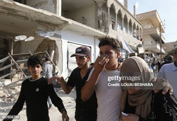 Syrian man from the recently retaken desert town of Al-Qaryatain is greeted by relatives on October 29 after the Syrian army reportedly freed him...