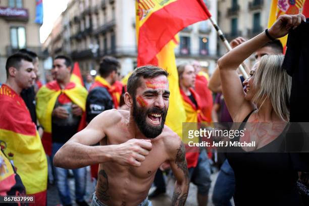 Nationalist supporters gather outside the Palau Catalan Regional Government Building following a pro-unity protest in Barcelona, two days after the...