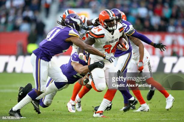 Isaiah Crowell of the Cleveland Browns is tackled by Anthony Harris of the Minnesota Vikings during the NFL International Series match between...