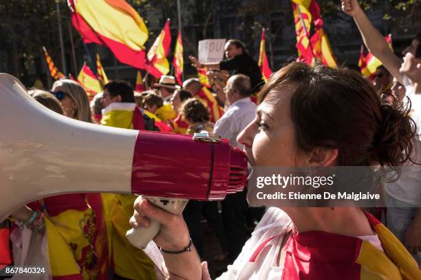 Woman shouts through a megaphone during a pro-unity demonstration on October 29, 2017 in Barcelona, Spain. Thousands of pro-unity protesters have...