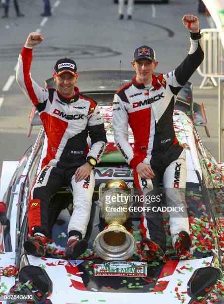 British pilot Elfyn Evans and co pilot Daniel Barritt of the M-Sport World Rally celebrate with their trophy after winning the 2017 Wales Rally GB,...