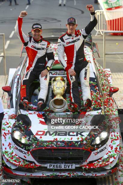 British pilot Elfyn Evans and co pilot Daniel Barritt of the M-Sport World Rally celebrate with their trophy after winning the 2017 Wales Rally GB,...