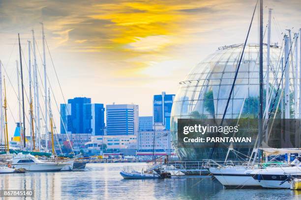 View of the port of genoa dominated by an aquarium and the biosphere greenhouse design with sunset sky.