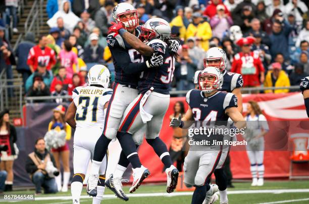 Brandon Bolden of the New England Patriots reacts with Trevor Reilly after a tackle during the first quarter of a game against the Los Angeles...
