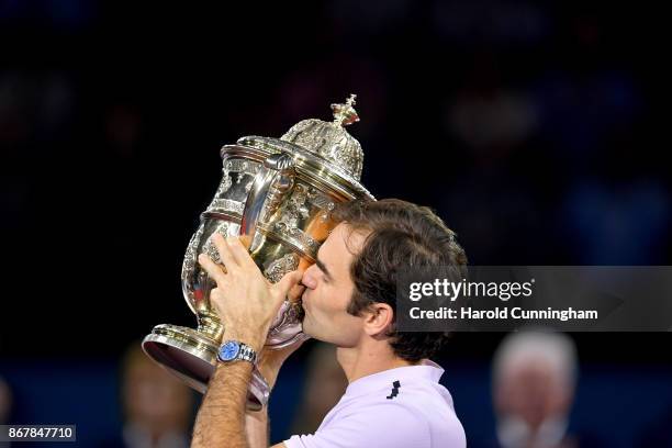 Roger Federer of Switzerland lifts the trophy as he celebrates his victory during the final match of the Swiss Indoors ATP 500 tennis tournament...