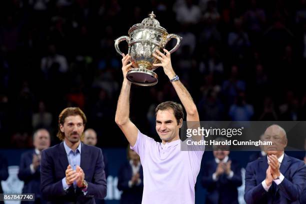 Roger Federer of Switzerland lifts the trophy as he celebrates his victory during the final match of the Swiss Indoors ATP 500 tennis tournament...
