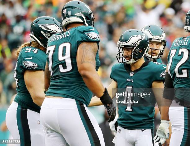 Jake Elliott of the Philadelphia Eagles is congratulated by teamamtes Beau Allen and Brandon Brooks after Elliott kicked a field goal in the first...