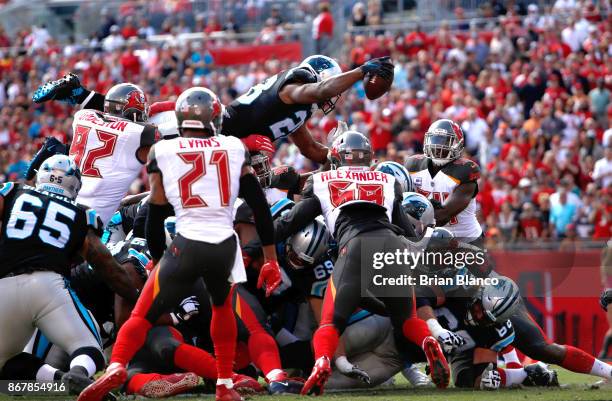 Running back Jonathan Stewart of the Carolina Panthers jumps over the pile on a 1-yard rush for a touchdown during the first quarter of an NFL...