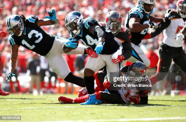 Running back Cameron Artis-Payne of the Carolina Panthers is brought down by middle linebacker Kwon Alexander of the Tampa Bay Buccaneers and strong...