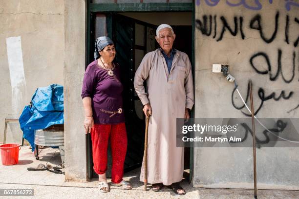 Sabitha Franca, 67 years old, and her husband Aziz Suleiman Shabi, 85 years old, outside a house in the Christian town of Karemles, Iraq, on...