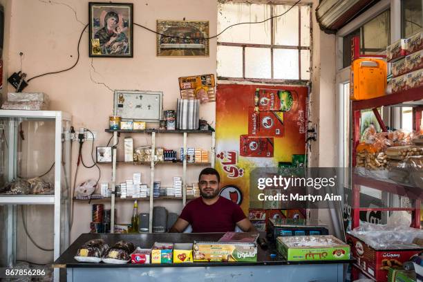 Maher Labeab, 24 years old, works in his family shop. They have recently returned to their Catholic town of Karemles, Iraq, on September 8, 2017.