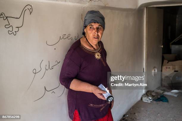 Sabitha Franca, 67 years old, visits her badly damaged home which is unlivable in the Catholic town of Karemles, Iraq, on September 8, 2017. Islamic...