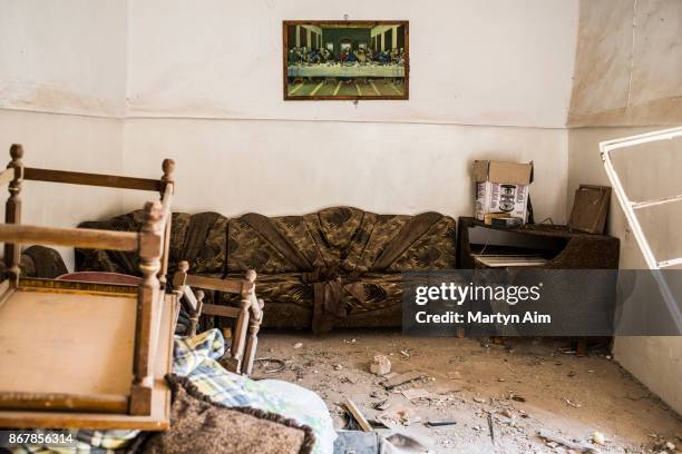 Painting of the Last Supper on the wall of a badly damaged home which is now unlivable in the Catholic town of Karemles, Iraq, on September 8, 2017.