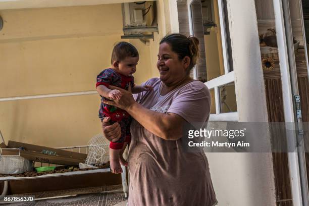 Chaldean Catholic mother and her child in Karamles, a Christian town in northern Iraq, on September 8, 2017.