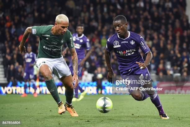 Toulouse's Ivorian forward Max-Alain Gradel vies for the ball with Saint-Etienne's French defender Leo Lacroix during the French L1 football match...