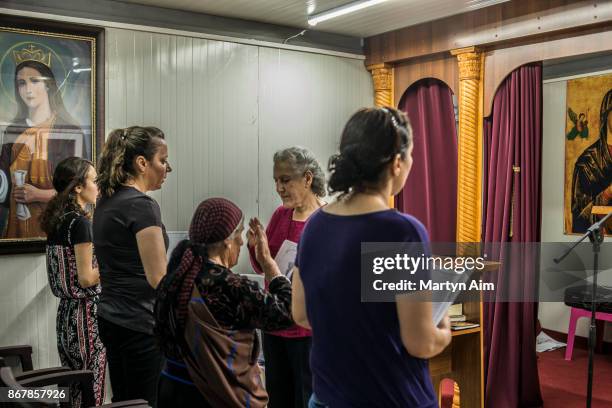 Chaldean Catholic women pray in the chapel in the Karemles Complex in Erbil, northern Iraq, on September 8, 2017. They have been living here for...