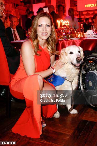 German presenter Jule Goelsdorf with an assistance dog during the 8th VITA Charity Gala on October 28, 2017 in Wiesbaden, Germany.