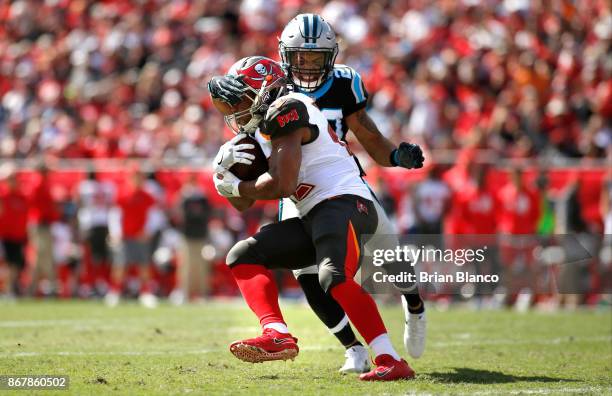 Running back Doug Martin of the Tampa Bay Buccaneers is stopped by free safety Kurt Coleman of the Carolina Panthers as he runs for a first down...