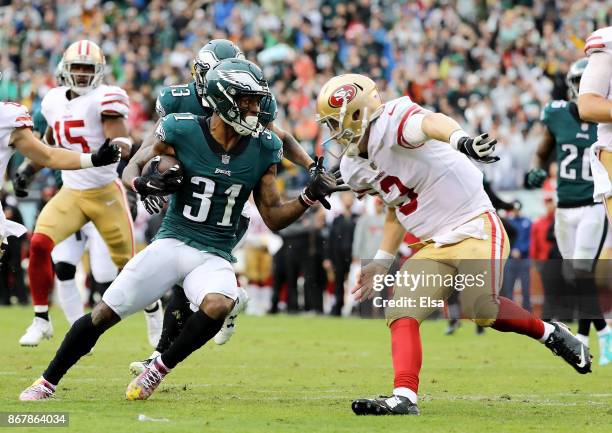 Beathard of the San Francisco 49ers tries to tackle Jalen Mills of the Philadelphia Eagles after Mills intercepted his pass and ran it in for a...