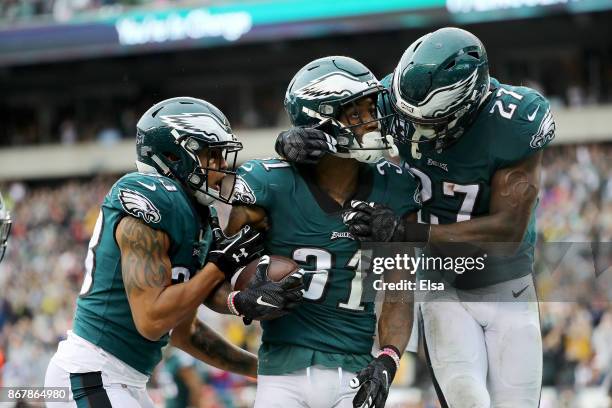 Jalen Mills of the Philadelphia Eagles is congratulated by teammates Dexter McDougle and Malcolm Jenkins after Mills picked off a pass from C.J....