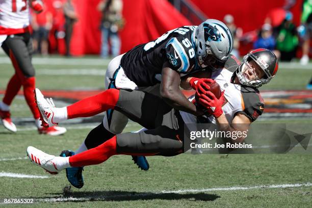 Thomas Davis of the Carolina Panthers tackles Adam Humphries of the Tampa Bay Buccaneers in the second quarter of a game at Raymond James Stadium on...