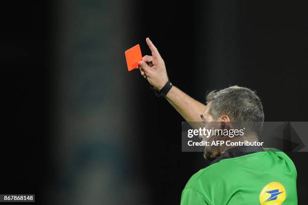 The referee Jerome Garces gives a red card to La Rochelle's French lock William Demotte during the French Top 14 rugby union match between La...