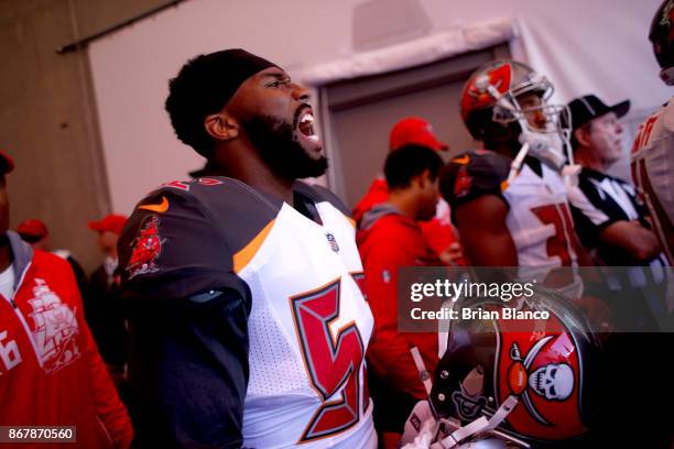 Linebacker Cameron Lynch of the Tampa Bay Buccaneers screams as he lines up with teammates in the tunnel before taking to the field to take on the...
