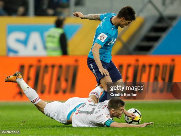 Emiliano Rigoni of FC Zenit Saint Petersburg and Igor Denisov of FC Lokomotiv Moscow vie for the ball during the Russian Football League match...