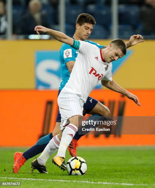 Emiliano Rigoni of FC Zenit Saint Petersburg and Igor Denisov of FC Lokomotiv Moscow vie for the ball during the Russian Football League match...