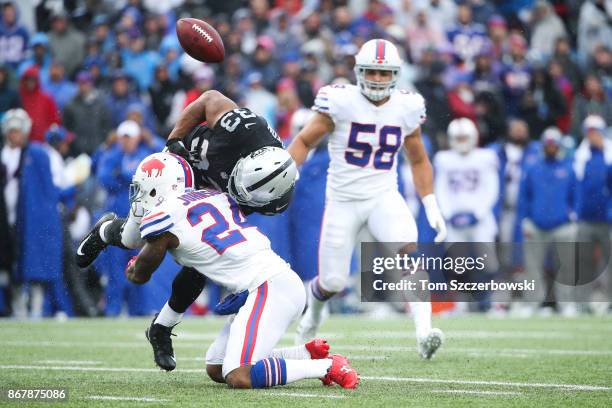 Leonard Johnson of the Buffalo Bills forces a fumble while tackling DeAndre Washington of the Oakland Raiders during the second quarter of an NFL...